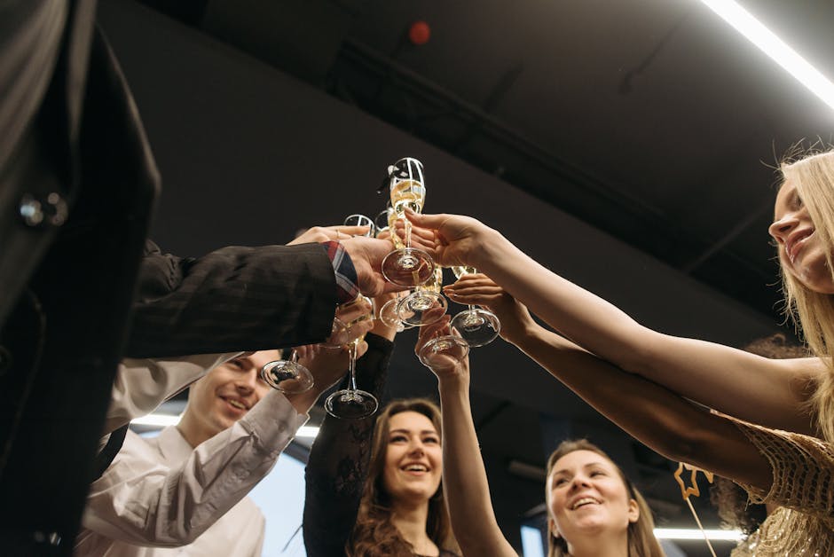 Friends raising glasses in celebration, smiling and toasting indoors
